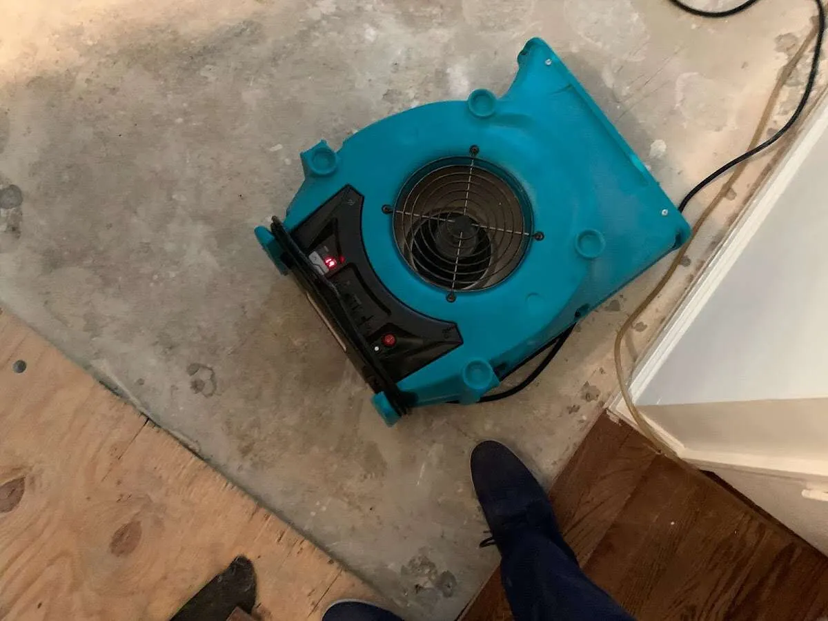 Air mover drying subfloor during Commercial Water Damage Restoration in Ottawa